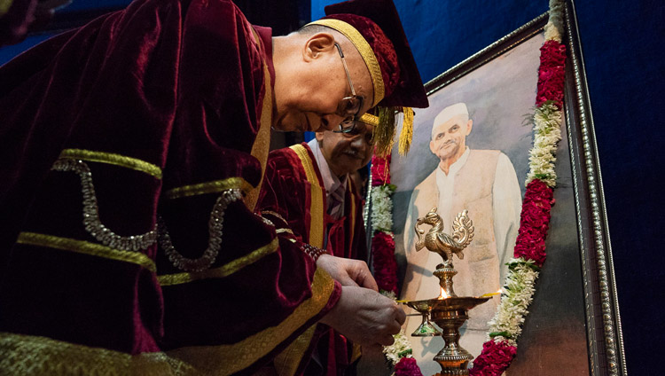 Sua Santità il Dalai Lama accende una lampada votiva e offre fiori davanti al ritratto di Lal Bahadur Shastri, prima dell'inizio della Cerimonia delle lauree presso il Lal Bahadur Shastri Institute of Management di Nuova Delhi, India, 23 aprile 2018. Foto di Tenzin Choejor