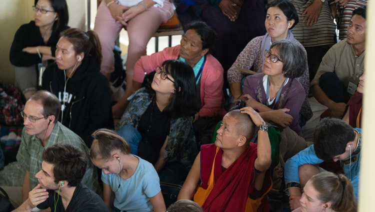 I praticanti nella veranda esterna del Tempio Principale Tibetano ascoltano Sua Santità il Dalai Lama attraverso i maxi schermi. Dharamsala, (India), il 4 settembre 2019. Foto di Tenzin Choejor